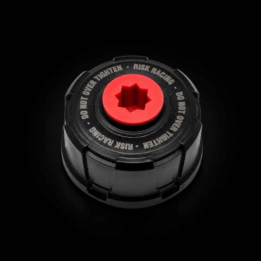 Black cap with red center and text on a white background