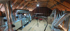 Attic space with insulation and ductwork in a home renovation setting lit up by a FLi-LITE